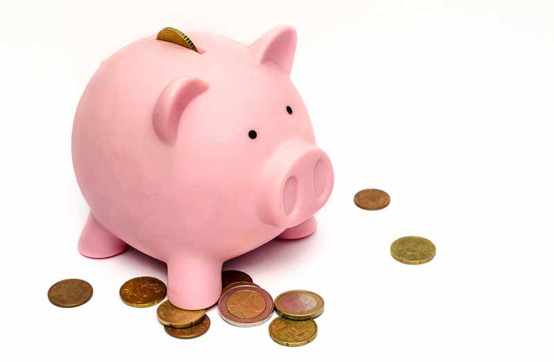 Piggy bank with coins around it at Sandstone Creek Club, Hotel and Timeshares in Vail, Colorado